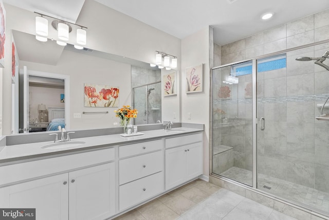 bathroom featuring vanity and a shower with door