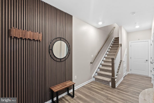 stairs featuring wood-type flooring