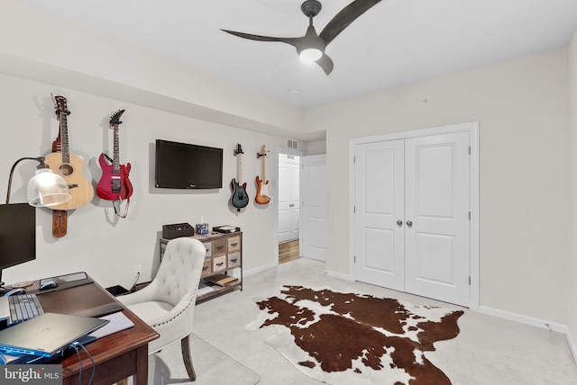 office space featuring ceiling fan and light colored carpet