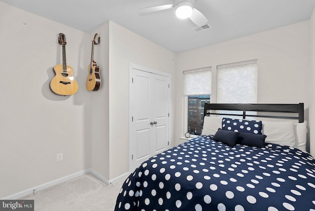 carpeted bedroom with a closet and ceiling fan