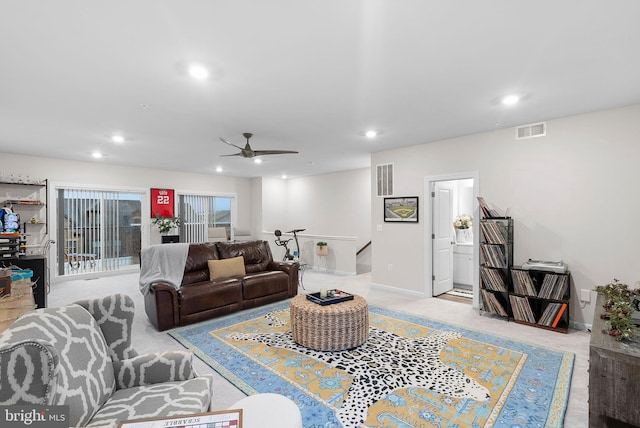 living room featuring light colored carpet and ceiling fan