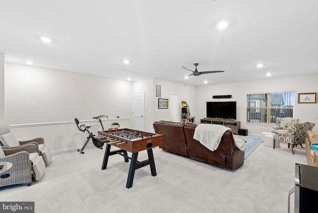 living room with ceiling fan and light colored carpet