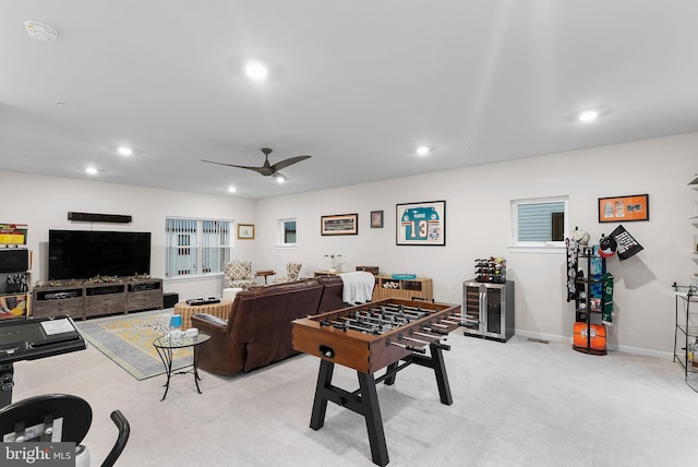 recreation room featuring ceiling fan and light colored carpet