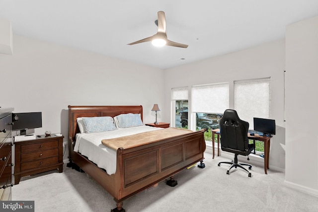 bedroom featuring light colored carpet and ceiling fan