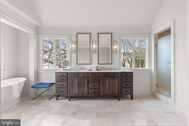 bathroom featuring vanity, vaulted ceiling, and independent shower and bath