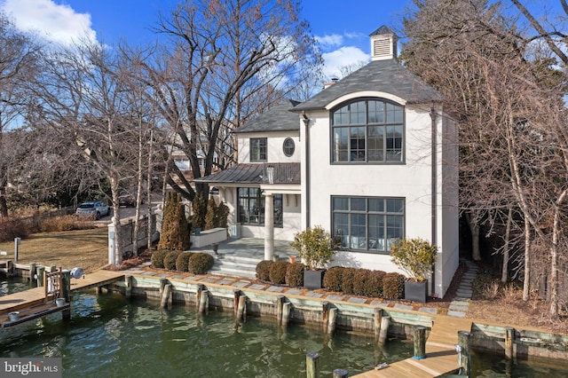 back of house with a water view