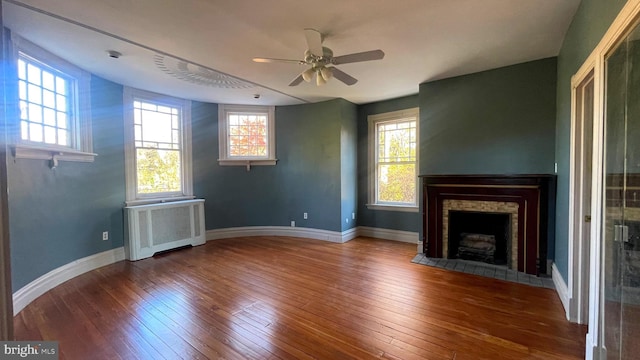 1250 Ashbourne Rd, Elkins Park, PA 19027 - unfurnished living room featuring radiator, healthy amount of natural light, and hardwood / wood-style floors