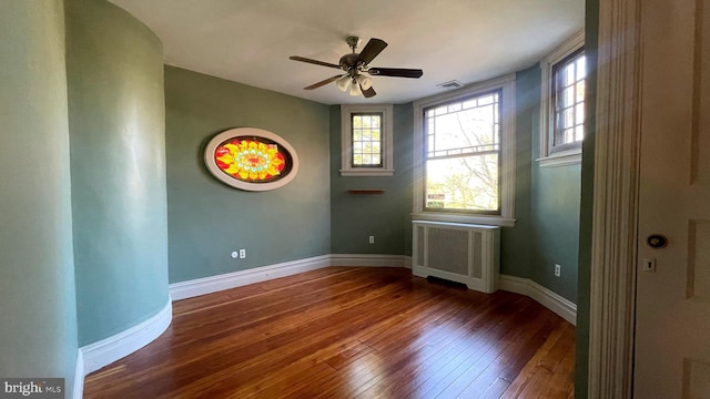 1250 Ashbourne Rd, Elkins Park, PA 19027 - empty room with radiator heating unit, hardwood / wood-style floors, and a ceiling fan