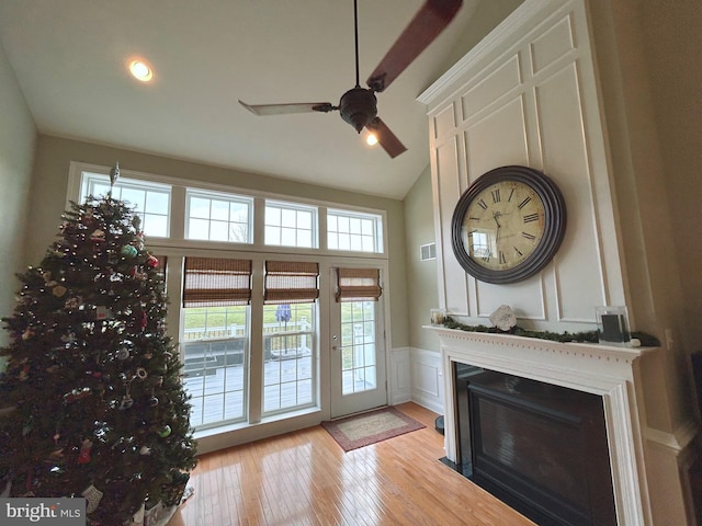 doorway featuring ceiling fan, light hardwood / wood-style floors, and lofted ceiling