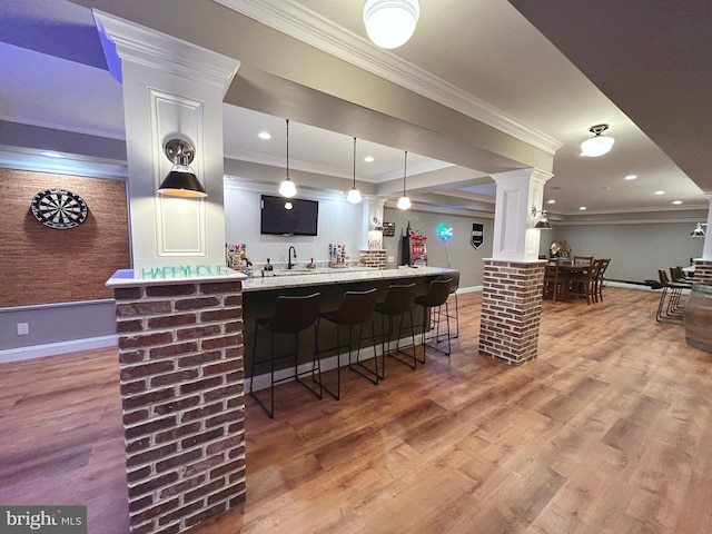 bar with white cabinetry, crown molding, hardwood / wood-style floors, and decorative light fixtures