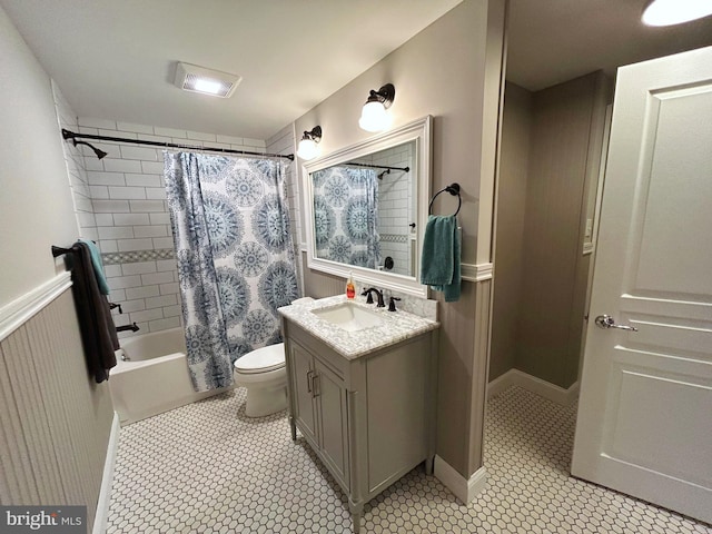 full bathroom featuring tile patterned floors, shower / bathtub combination with curtain, vanity, and toilet