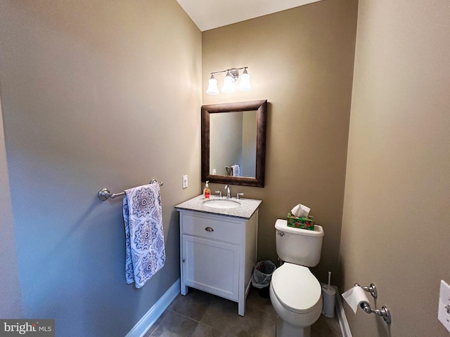 bathroom featuring tile patterned floors, vanity, and toilet