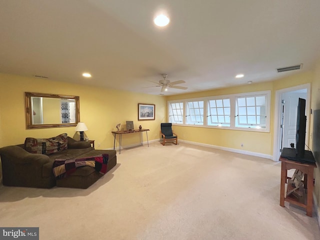 carpeted living room with ceiling fan