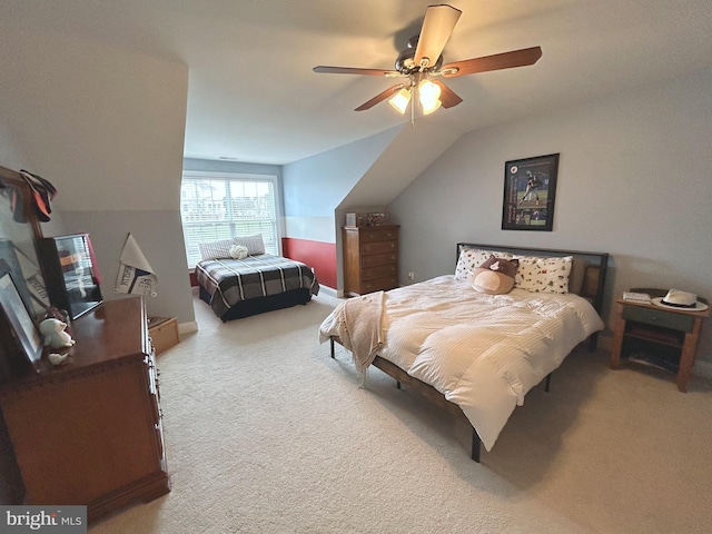 carpeted bedroom featuring ceiling fan and lofted ceiling