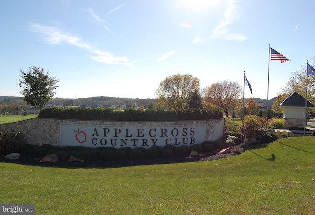 community sign featuring a lawn