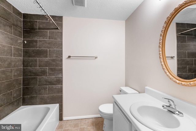 full bathroom featuring vanity, washtub / shower combination, a textured ceiling, and toilet