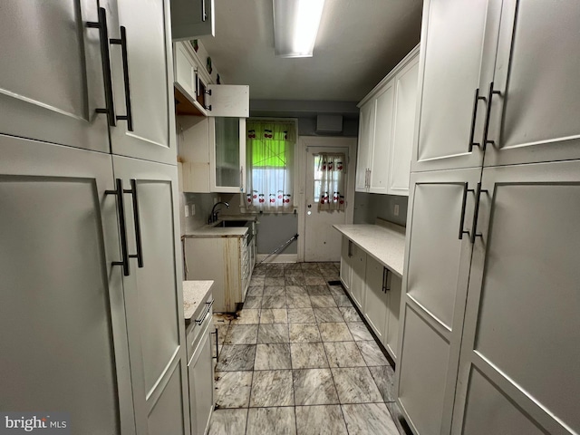 kitchen with light stone countertops and white cabinets