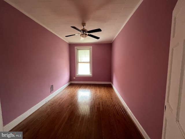 empty room with hardwood / wood-style floors, ceiling fan, and crown molding