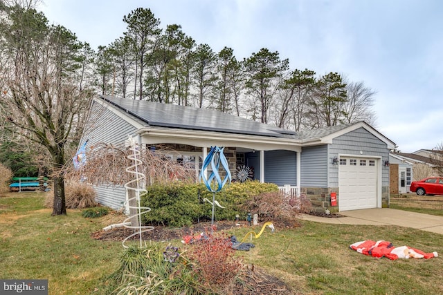 view of front of house with a front lawn, a garage, a porch, and solar panels