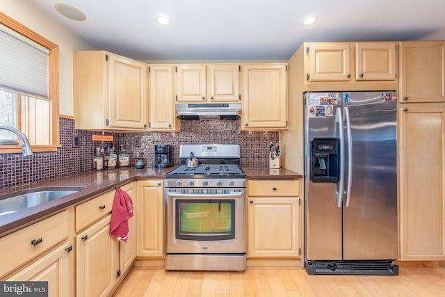 kitchen with light brown cabinetry, sink, appliances with stainless steel finishes, and tasteful backsplash