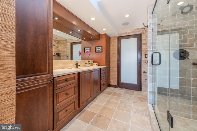 bathroom with decorative backsplash, vanity, and a shower with shower door