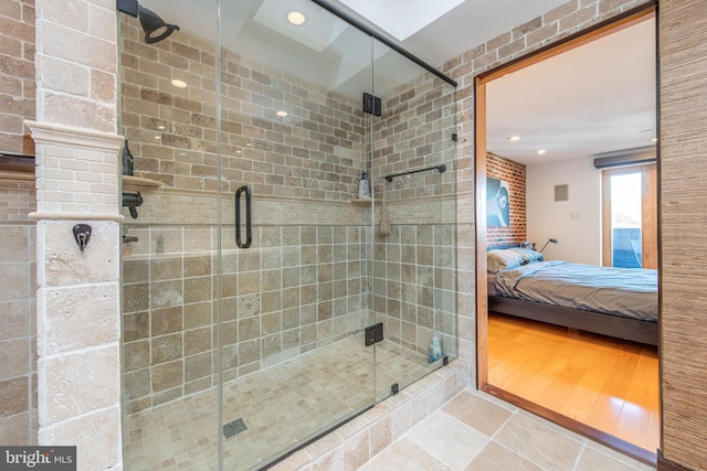 bathroom featuring a shower with door