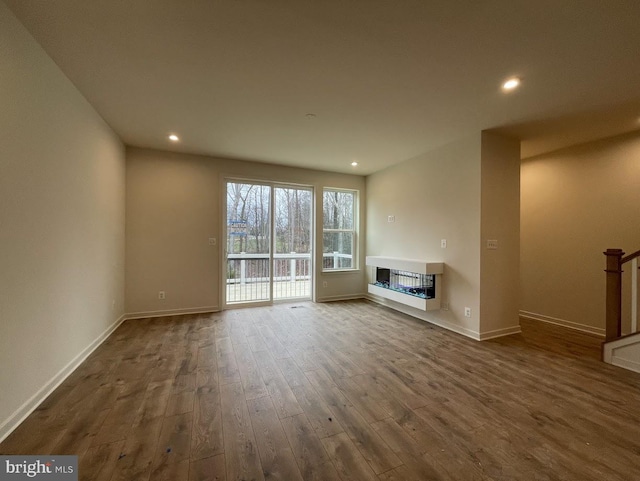 unfurnished living room with dark hardwood / wood-style floors