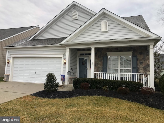 view of front of home featuring a front lawn, a garage, and a porch