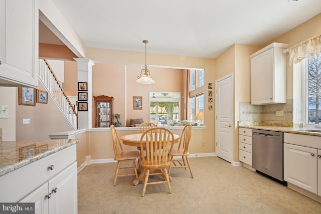 kitchen featuring light colored carpet, white cabinetry, dishwasher, and light stone countertops