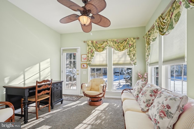 interior space featuring ceiling fan and carpet