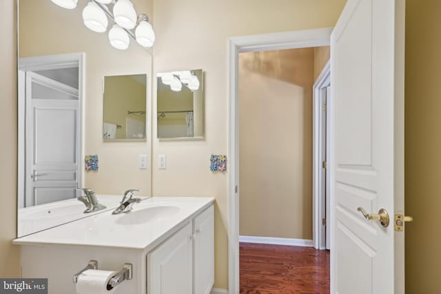 bathroom with hardwood / wood-style floors and vanity