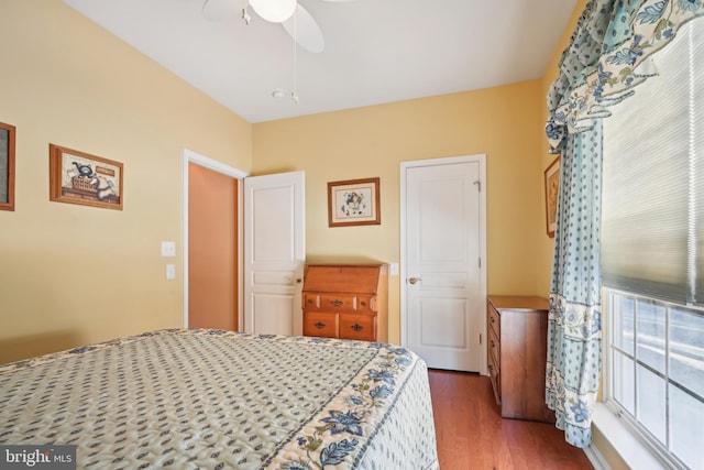 bedroom with ceiling fan and dark wood-type flooring