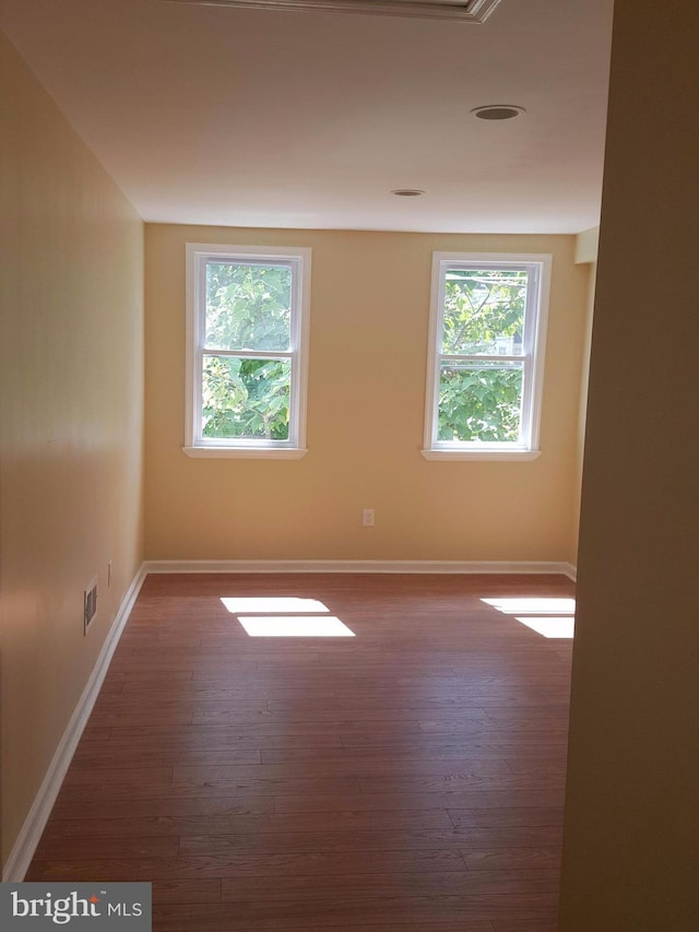 unfurnished room featuring dark hardwood / wood-style flooring