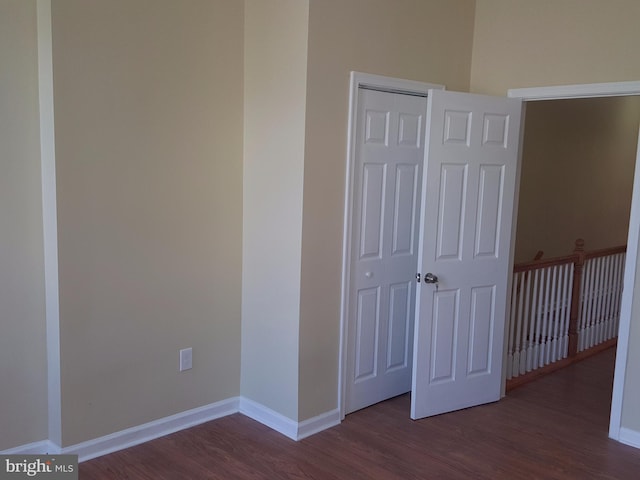 interior space with dark wood-type flooring and a closet