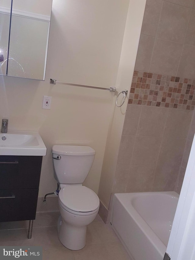 bathroom featuring tile patterned flooring, vanity, and toilet