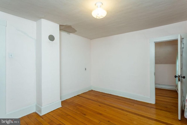 spare room featuring hardwood / wood-style floors