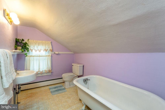 bathroom featuring a bathing tub, baseboard heating, a textured ceiling, vaulted ceiling, and toilet