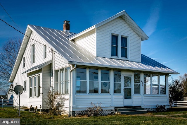 back of property featuring a sunroom