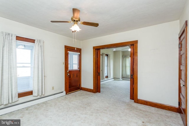 unfurnished room with ceiling fan, light carpet, and a baseboard heating unit