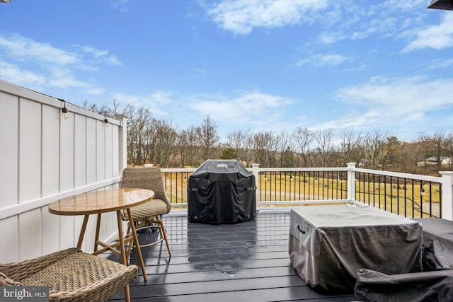 wooden terrace featuring a grill