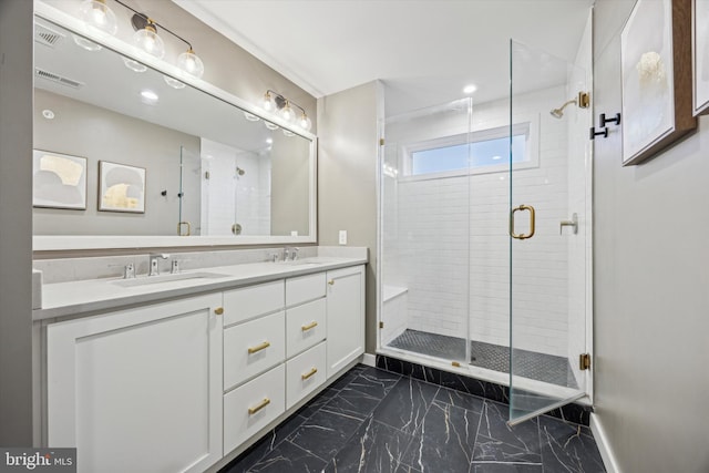 bathroom with vanity and a shower with door