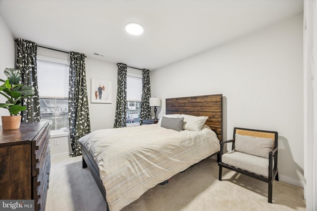 bedroom with light colored carpet