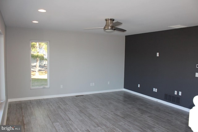 empty room featuring dark hardwood / wood-style flooring and ceiling fan