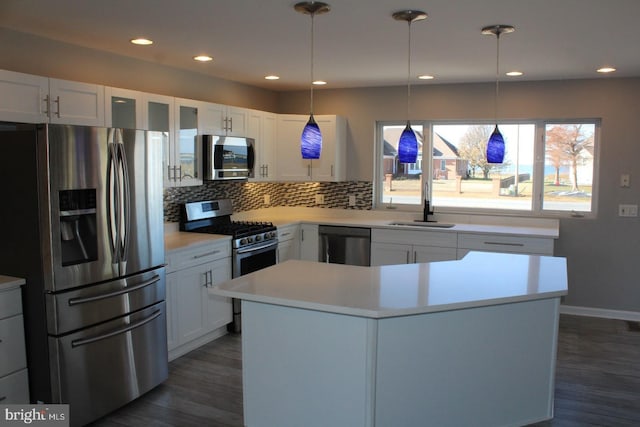 kitchen featuring white cabinets, appliances with stainless steel finishes, dark hardwood / wood-style flooring, and tasteful backsplash