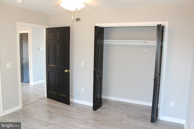 unfurnished bedroom featuring a closet, ceiling fan, and light hardwood / wood-style flooring