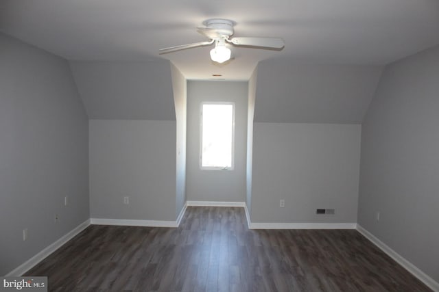 additional living space featuring ceiling fan, lofted ceiling, and dark wood-type flooring