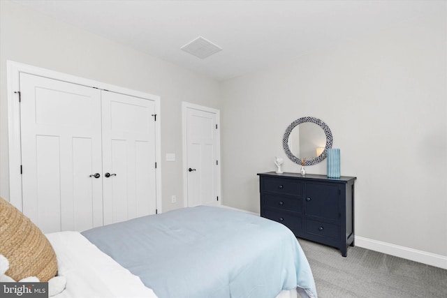 bedroom with a closet and light colored carpet