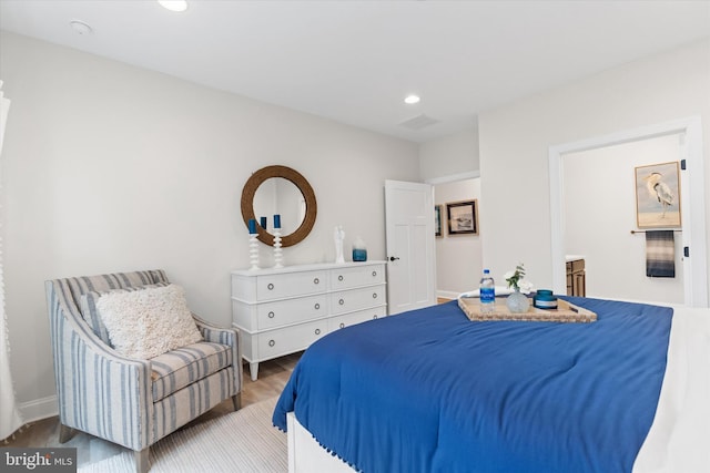 bedroom with hardwood / wood-style floors