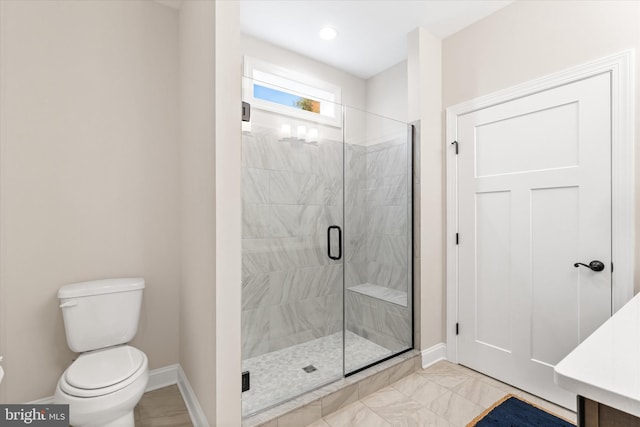 bathroom with vanity, toilet, and a shower with shower door