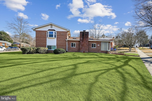 back of house with a lawn